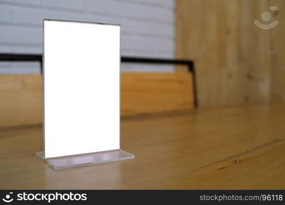 Mock up Menu frame standing on wood table in Bar restaurant cafe. space for text