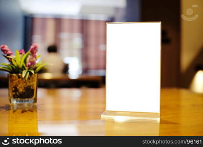 Mock up Menu frame standing on wood table in Bar restaurant cafe. space for text