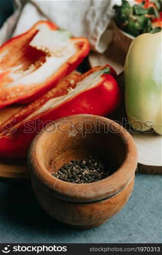 Mock up of a cooking table with a pepper cut in half a knife and some condiments