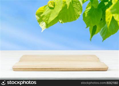Mock-up of organic outdoor cooking or product presentation- empty wooden plank on the table (mixed)