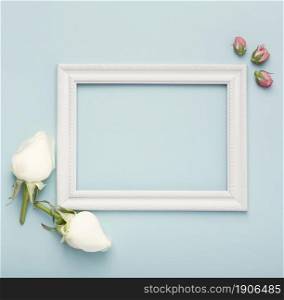 mock up white horizontal empty frame with rosebuds blue background. High resolution photo. mock up white horizontal empty frame with rosebuds blue background. High quality photo