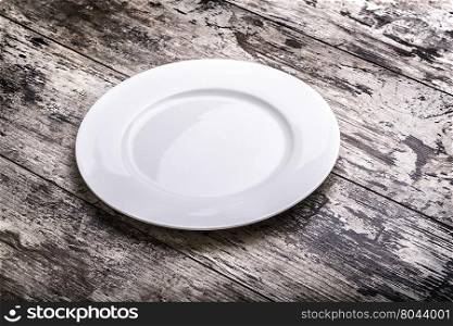 Mock up white plate on white wooden table