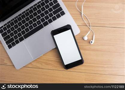 Mockup blank screen mobile phone on office desk with copy space top view table.