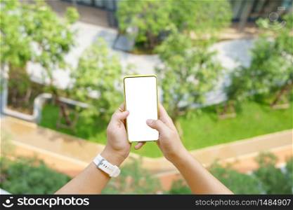 Mockup image of Woman hand holding mobile smartphones isolated white screen for mockup design and others app display background. Graphic design montage