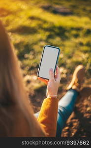 Mockup of a woman with her phone at sunset