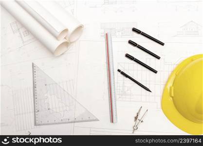 Mockup of architectural concept, Drawing tools and engineer drawing on blueprint with safety helmet.