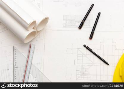 Mockup of architectural concept, Drawing tools and engineer drawing on blueprint with safety helmet.