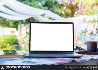 Mockup of laptop computer with empty screen with coffee cup and smartphone on table beside the window of the coffee shop background,White screen