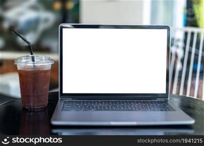 Mockup of laptop computer with empty screen with coffee isolate on wooden office desk in coffee shop like the background ,White screen