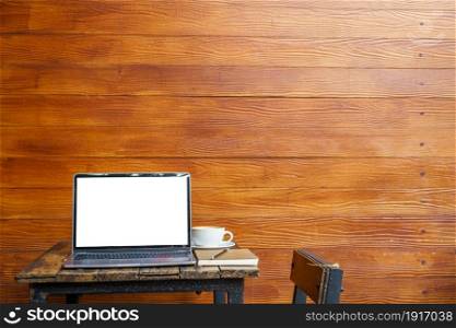 Mockup of laptop computer with empty screen with notebook,coffee cup and smartphone on table of tree branch shadow the cafe coffee shop background,White screen