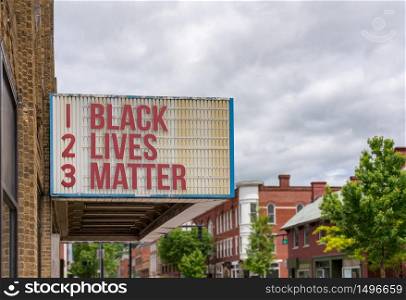 Mockup of movie cinema billboard with message of Black Lives Matter on the marquee in downtown street. Mockup of movie cinema billboard with Black Lives Matter on the message board