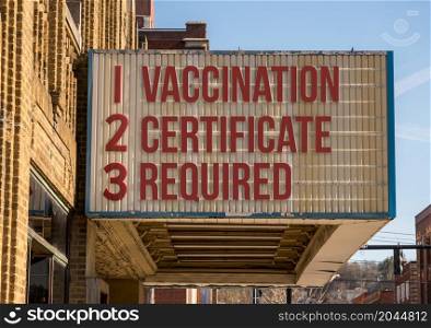 Mockup of movie cinema billboard with vaccination mandate for entry into public areas during coronavirus or Covid-19 epidemic. Concept of vaccination mandate for entry into public areas on cinema board