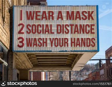 Mockup of movie cinema billboard with wear a mask, social distance and wash hands to deal with the coronavirus epidemic.. Mockup of recommendations to Flatten the Curve to avoid Coronavirus on cinema marquee board