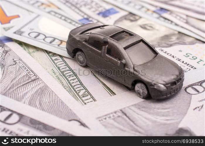 Model car placed US dollar banknotes spread on ground