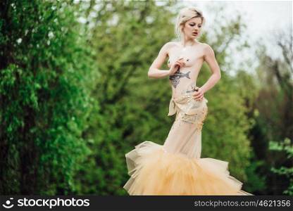 model girl dress gold angel posing in the woods near the old columns