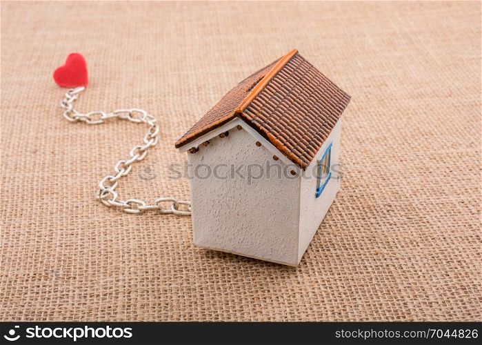 Model house and chain with a heart on canvas