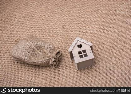 Model house beside a sack on a canvas background