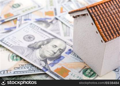 Model house is placed US dollar Banknotes on spread on the background