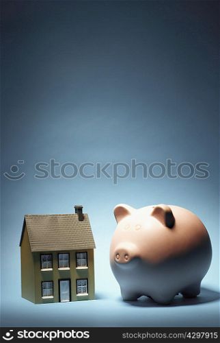Model house next to piggy bank