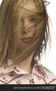 Model looking through her wind swept hair.
