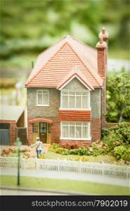 model of a generic british 1950 style suburban detached house and garden