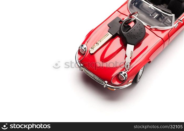 Model of a red car with padlock on white background, view from above. Concept of buying or selling a car. Close up, copy space.