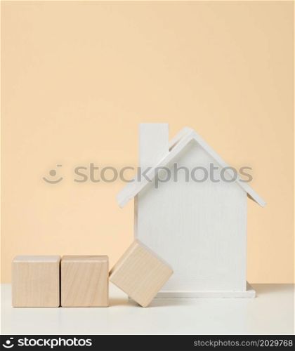 model of a white wooden house. Real estate tax payment concept