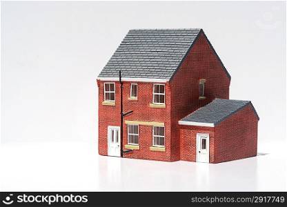 Model of detached house on white background