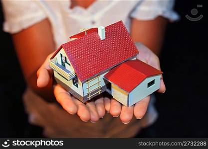 model of house with garage on hands