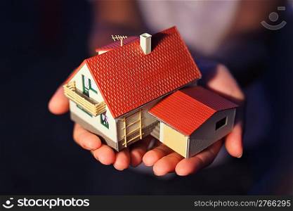 model of house with garage on hands