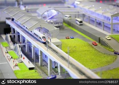 model of railroad station. railroad, train, buildings and other constructions. focus on a front of train