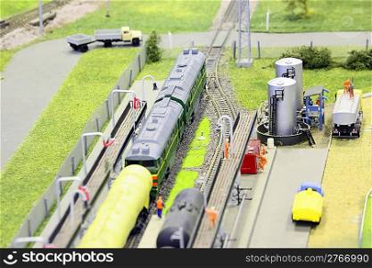 model of railroad station. railroad, trains and some constructions. focus on cistern.