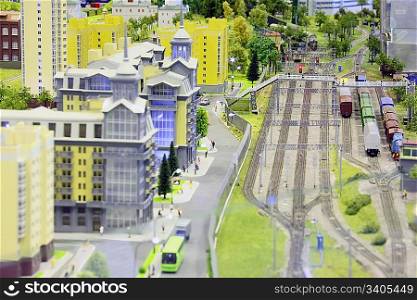 model of railroad station. railroad, trains, buildings and other constructions. focus on a bridge.