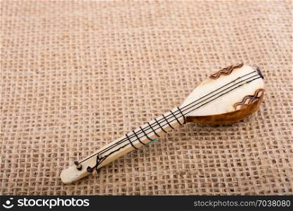 Model of Turkish musical instrument saz on a linen canvas
