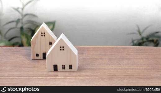 Model of wooden houses on table with copy space