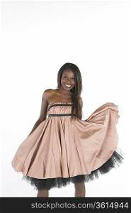 Model stands smiling in pink dress with petticoats