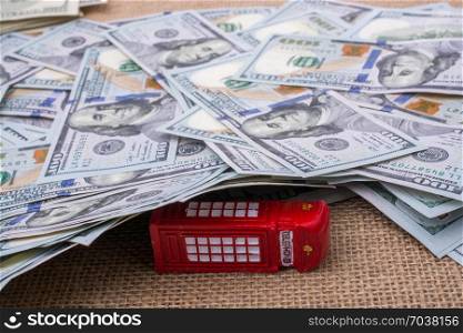 Model telephone booth is covered by the spread US dollar Banknotes