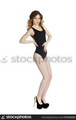 Model tests, Young slim woman posing in black leotard, isolated on white