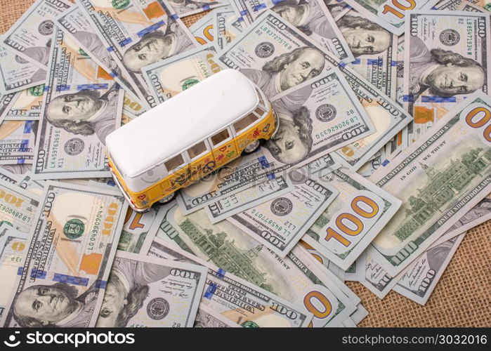 Model van placed US dollar banknotes . Model van placed US dollar banknotes spread on ground