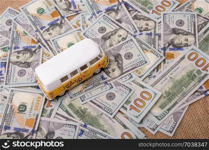 Model van placed US dollar banknotes spread on ground