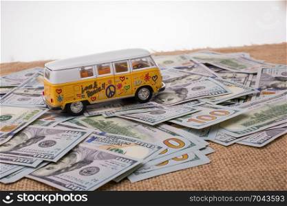 Model van placed US dollar banknotes spread on ground