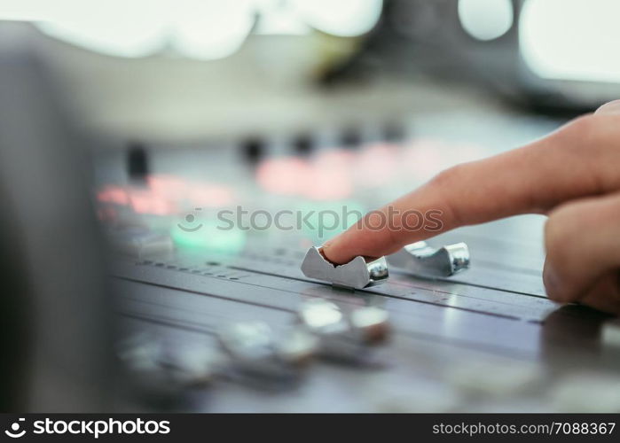 Moderator and soundboard in radio broadcasting studio