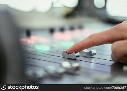 Moderator and soundboard in radio broadcasting studio