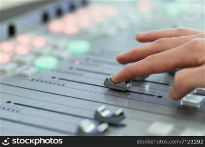 Moderator and soundboard in radio broadcasting studio