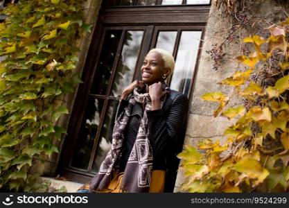 Modern african american woman posin outdoor at autumn