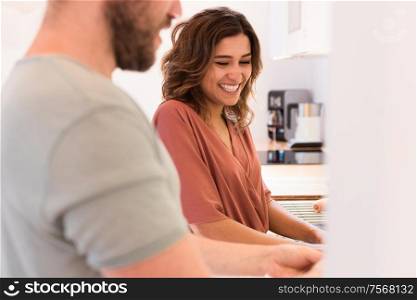 Modern and young couple cooking together at home