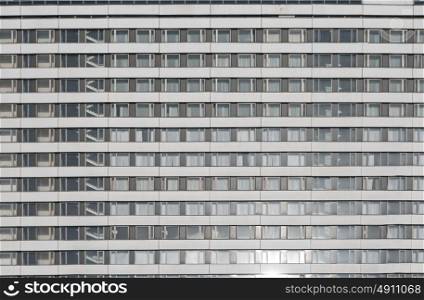 Modern apartment building wall with windows background