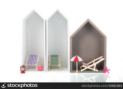 Modern beach houses with deck chairs isolated over white background
