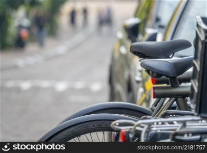 Modern bicycles are parked on the street. Very shallow depth of field. Parked Bicycles With Defocused Background