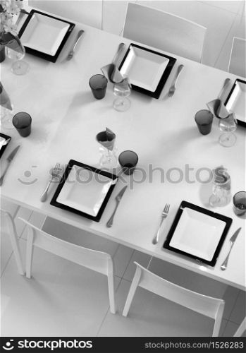 Modern black and white dining table setting seen above. Fine table setting seen above